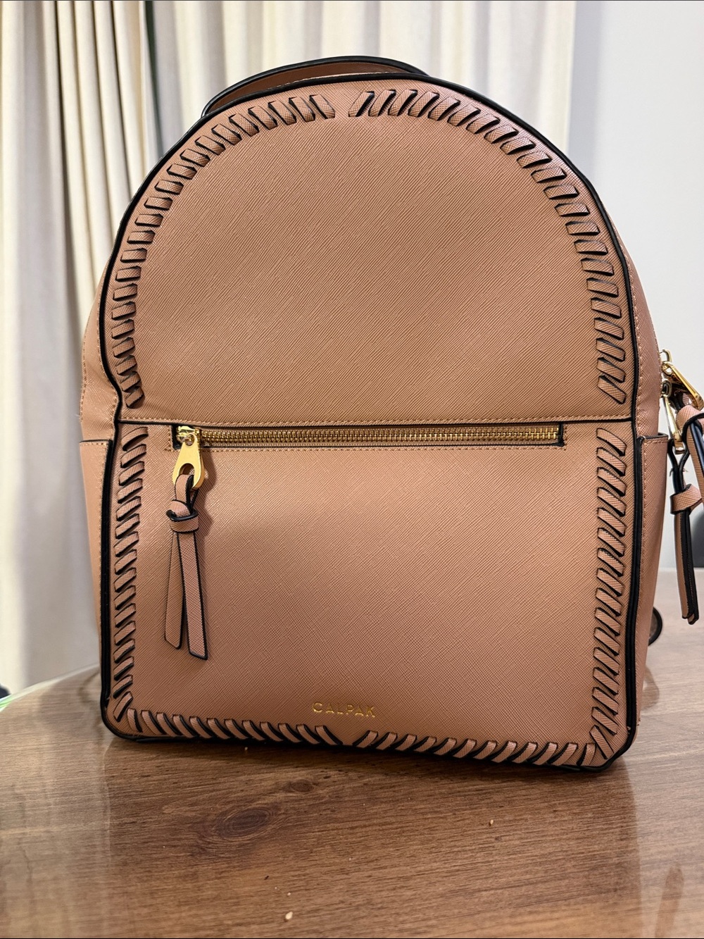 Calpak Kaya faux leather round travel backpack